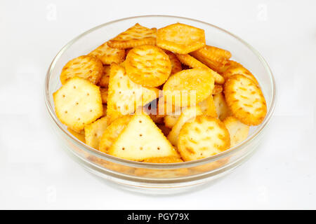 Mini crackers on glass bowl on white backround Stock Photo