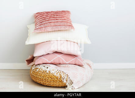 Pink and white pillows on the wall background. Close up Stock Photo