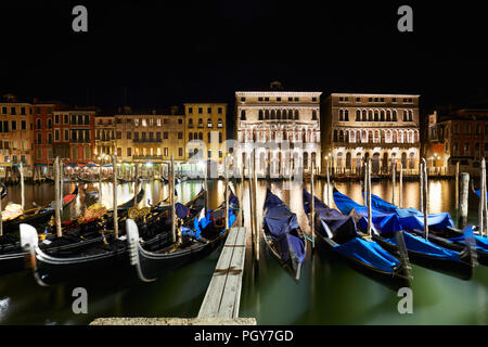 Grand Canal illuminated in Venice with gondolas at night, Italy