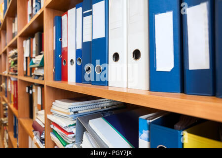Perspective view at of colourful binders sorted on office shelves, an archive Stock Photo