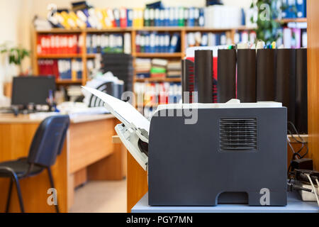 Office supply: printer device is in empty corporate room Stock Photo
