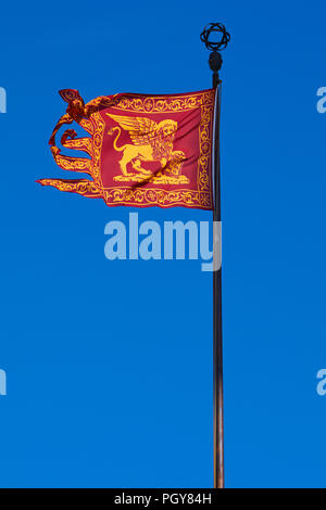 Venice, traditional Serenissima flag with Saint Mark lion, blue sky in a sunny day Stock Photo