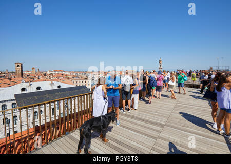 VENICE, ITALY - AUGUST 15, 2017: Fondaco dei Tedeschi, luxury department store terrace with people looking at the city in a sunny summer day Stock Photo