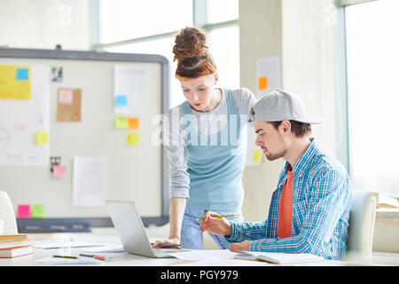 Busy marketing colleagues concentrated on data analyzing papers while working in office Stock Photo