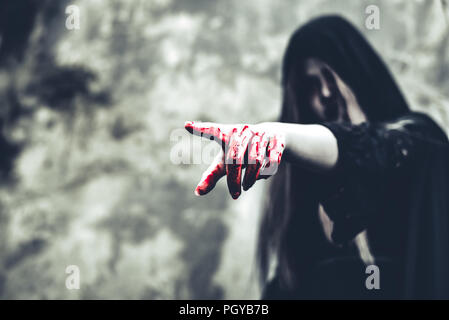 Close up of bloody ghost hand pointing to the front. Horror and ghost concept. Halloween and scary movie theme. Abandoned house theme Stock Photo