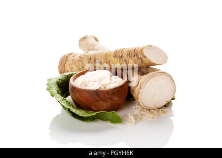 Fresh and grated horseradish roots isolated on white background. Stock Photo