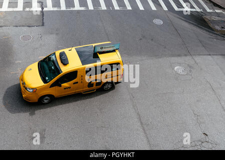 New York City, USA - June 22, 2018: Yellow taxi cab in Manhattan. High angle view. Nissan NV200 is the model of the New York City taxi Stock Photo