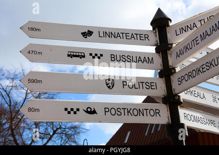 KURESSAARE, ESTONIA - CIRCA MAR, 2018: Direction plates are on guidepost on city street. Ways to theater, police, bus station and post office. Saarema Stock Photo