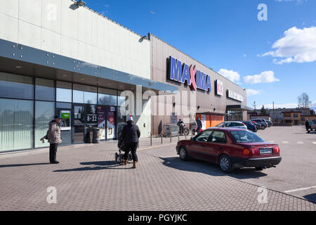 KURESSAARE, ESTONIA - CIRCA MAR, 2018: Main entrance of building of supermarket Maxima XX with visitors. It is one of the largest shops is on Saaremaa Stock Photo