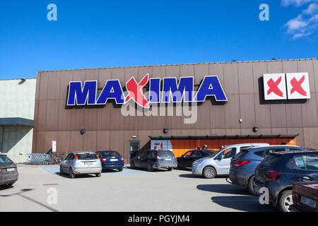 KURESSAARE, ESTONIA - CIRCA MAR, 2018: Parking lot of supermarket Maxima XX is in center of city. Main entrance and logo. It is one of the largest sho Stock Photo