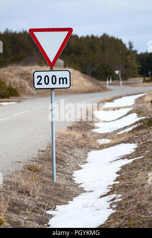Roadsign yield ahead after 200 meters on roadside Stock Photo