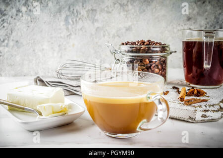 Trendy ketogenic diet food, Bulletproof coffee with milk and butter, white marble background copy space Stock Photo