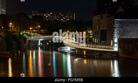 Bristol, England, UK - August 9, 2018: The modern Castle Bridge footbridge snakes across Bristol's Floating Harbour at Finzel's Reach. Stock Photo