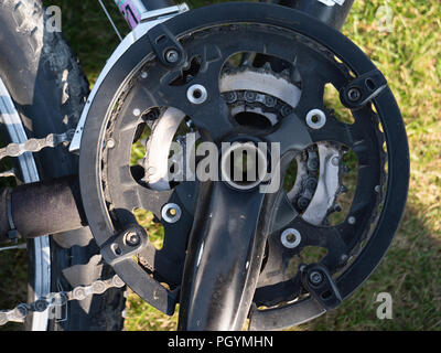 close up of pedal system at a dirty mountain bike with chain crankset Stock Photo