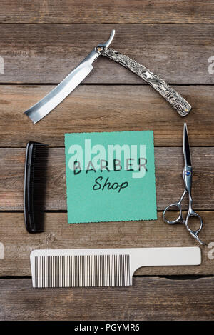 Barbershop sign on wooden background Stock Photo