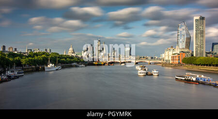 London, England, UK - June 12, 2018: Skyscrapers of the City of London rise behind the River Thames, Blackfriars Bridge and St Paul's Cathedral on a s Stock Photo