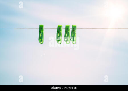 Clothespins on a rope against sky Stock Photo
