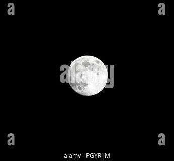 A full moon isolated against a black night sky in high resolution with ...