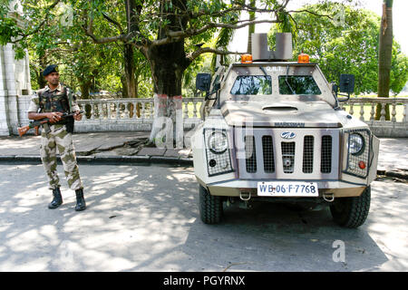 Kolkata, India - April 6, 2018 : young indian soldier guard holding light machine gun and marksman armoured vehicle are observed for anti-terrorism in Stock Photo