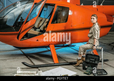 female helicopter mechanic at work. gender equality. feminism Stock Photo