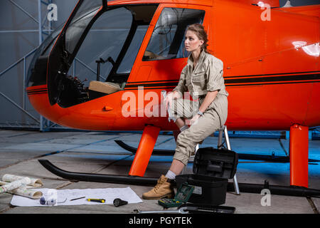 female helicopter mechanic at work. gender equality. feminism Stock Photo