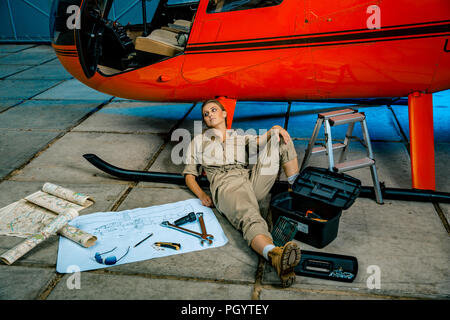 female helicopter technician tired at work. gender equality. feminism Stock Photo