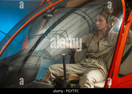 Attractive woman pilot sitting in the helicopter. gender equality. feminism Stock Photo