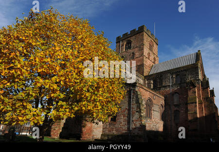 West side of Carlisle Cathedral, Cumbria, England, UK, with autumn colours Stock Photo