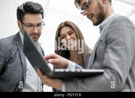 employees using a laptop to obtain the necessary information Stock Photo