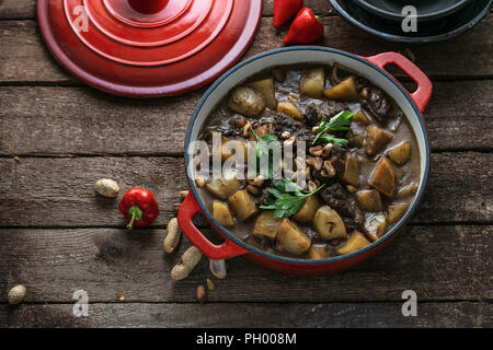 Famous thai dish massaman curry in red pan Stock Photo