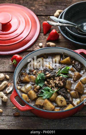 Famous thai dish massaman curry in red pan Stock Photo