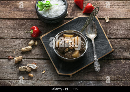 Thai Beef Massaman Curry with Rice, dark background copy space Stock Photo
