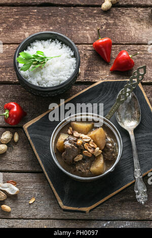Thai Beef Massaman Curry with Rice, dark background copy space Stock Photo