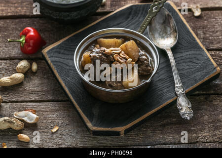 Thai Beef Massaman Curry with Rice, dark background copy space Stock Photo