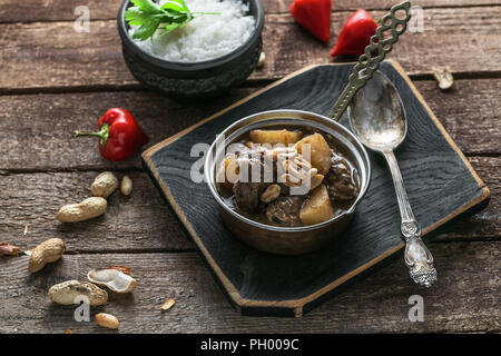 Thai Beef Massaman Curry with Rice, dark background copy space Stock Photo