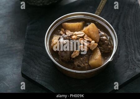 Close view of Massaman Curry with Rice, dark background copy space Stock Photo