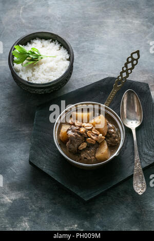 Thai Beef Massaman Curry with Rice, dark background copy space Stock Photo