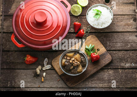 Massaman beef curry on wood background.coconut milk curry. Stock Photo