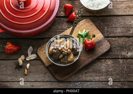 Massaman beef curry on wood background.coconut milk curry. Stock Photo