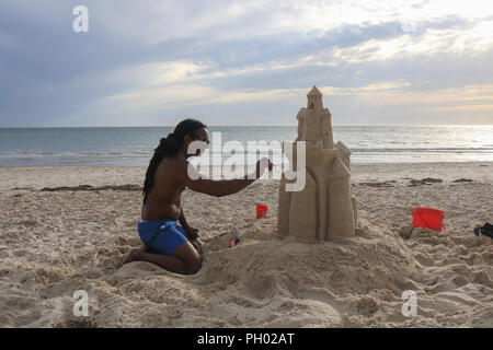 Adelaide Australia. 29 August 2018. A man builds a sandcastle in the coastal suburb of  Henley on a warm sunny afternoon. Adelaide is experiencing warmer temperatures  on the final stages of the Australian winter season and the onset of spring Credit: amer ghazzal/Alamy Live News Stock Photo