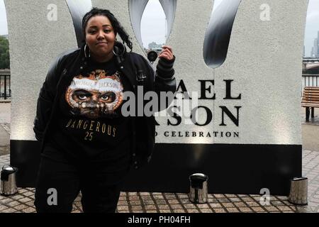 london 29th august 2018 superfan pose in front of a 13 foot high jewelled crown of the king of pop sony music in collaboration with the estate of michael jackson celebrate the king of pops diamond birthday celebration with the installation of a giant 13 foot jewelled crown at londons iconic southbank for one day only on what would have been the superstars birthday credit claire dohertyalamy live news ph04fh