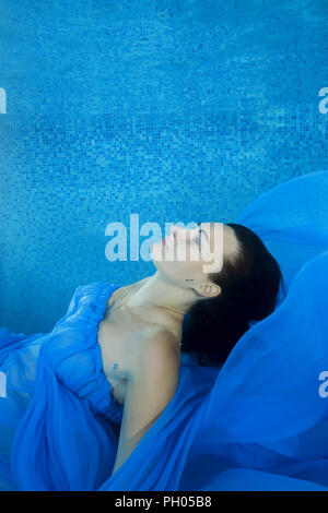 Odessa, Ukraine. 27th Aug, 2018. Pregnant woman in a blue dress posing underwater in the pool Credit: Andrey Nekrasov/ZUMA Wire/Ģ����ý Live News Stock Photo