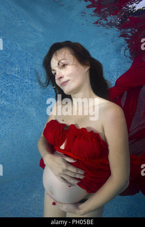 Odessa, Ukraine. 27th Aug, 2018. Pregnant woman in a red dress posing underwater in the pool Credit: Andrey Nekrasov/ZUMA Wire/Alamy Live News Stock Photo