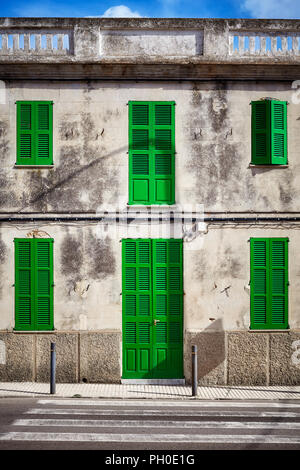 Mediterranean style old stone building facade with green door and shutters, Mallorca, Spain. Stock Photo