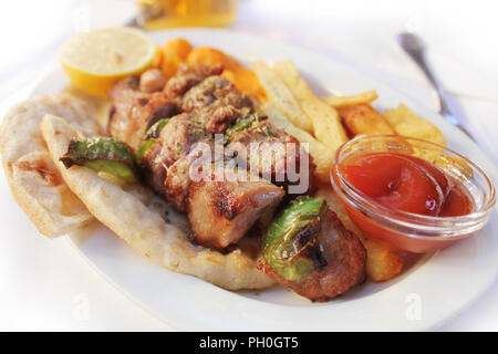 Greek food souviaki. Grilled meat skewer on pita bread Stock Photo