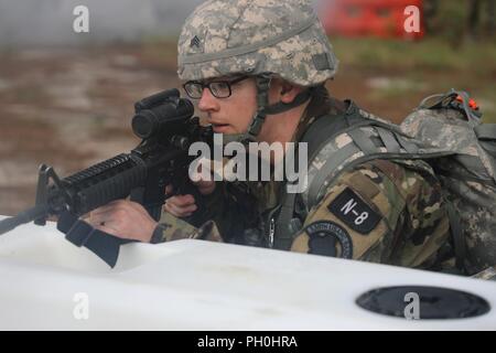 U.S. Army Reserve Sgt. Benjamin Moran, an Army Reserve musician from Granville, Ohio, with the 338th United States Army Reserve Command Band, 88th Readiness Division, competes in the tactical combat casualty care event at the 2018 U.S. Army Reserve Best Warrior Competition at Fort Bragg, North Carolina, June 14, 2018. Today, U.S. Army Reserve Soldiers give everything they have to push past their limits and finish the last day of events in the 2018 U.S. Army Reserve Best Warrior Competition. Stock Photo