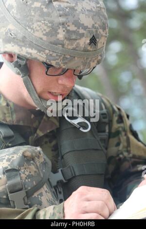 U.S. Army Reserve Sgt. Benjamin Moran, an Army Reserve musician from Granville, Ohio, with the 338th United States Army Reserve Command Band, 88th Readiness Division, competes in the tactical combat casualty care event at the 2018 U.S. Army Reserve Best Warrior Competition at Fort Bragg, North Carolina, June 14, 2018. Today, U.S. Army Reserve Soldiers give everything they have to push past their limits and finish the last day of events in the 2018 U.S. Army Reserve Best Warrior Competition. Stock Photo