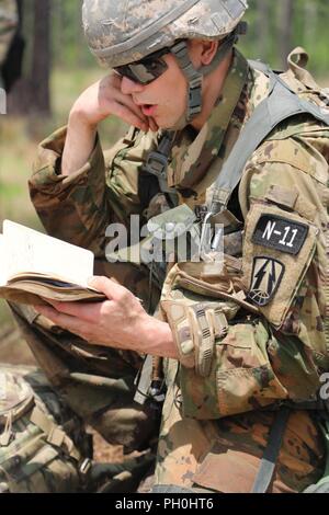 U.S. Army Reserve Sgt. Taylor Nelson, an intelligence analyst from Southborough, Massachusetts, with the North East Cyber Protection Center, 335th Signal Command (Theater), competes in the tactical combat casualty care event at the 2018 U.S. Army Reserve Best Warrior Competition at Fort Bragg, North Carolina, June 14, 2018. Today, U.S. Army Reserve Soldiers give everything they have to push past their limits and finish the last day of events in the 2018 U.S. Army Reserve Best Warrior Competition. Stock Photo