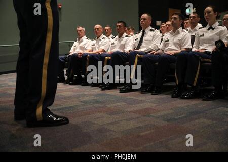 Warriors receive a speech from Command Sgt. Maj. Ted Copeland after competing in the 2018 U.S. Army Reserve Best Warrior Competition at Fort Bragg, North Carolina, June 14, 2018. Today, U.S. Army Reserve Soldiers give everything they have to push past their limits and finish the last day of the events in the U.S. Army Reserve Best Warrior Competition. Stock Photo