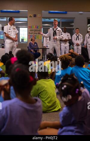 CHATTANOOGA, Tenn. (June 15, 2018) Electrician's Mate (Nuclear) 2nd Class Austin Scott, assigned to the Ohio-class ballistic-missile submarine USS Tennessee (SSBN 734), talks about his job on a submarine to children at the Highland Park Boys and Girls Club during Chattanooga Navy Week. Navy Weeks are designed to connect the public with Navy Sailors, programs and equipment throughout the country. Every year, America's Navy comes home to approximately 15 cities across the country to show Americans why having a strong Navy is critical to the American way of life. Stock Photo